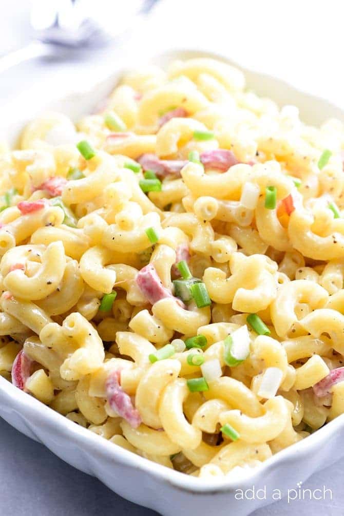 Southern Macaroni Salad Recipe - Southern Macaroni Salad makes a delicious addition for picnics, potlucks, and any get together! An easy make-ahead staple, this macaroni salad is a definite go-to recipe for your summer parties! // addapinch.com