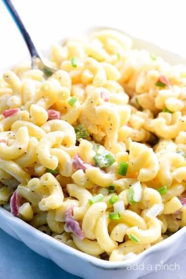 Southern Macaroni Salad Recipe - Southern Macaroni Salad makes a delicious addition for picnics, potlucks, and any get together! An easy make-ahead staple, this macaroni salad is a definite go-to recipe for your summer parties! // addapinch.com