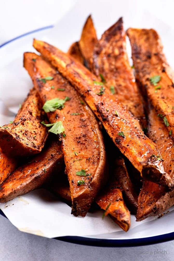 Spicy Sweet Potato Wedges Recipe - Spicy Roasted Sweet Potato Wedges make an easy and delicious recipe! Made with just five ingredients, these roasted sweet potatoes will definitely become a favorite! // addapinch.com