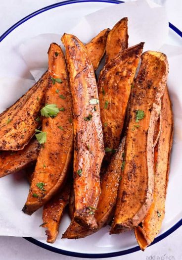 Spicy Sweet Potato Wedges Recipe - Spicy Roasted Sweet Potato Wedges make an easy and delicious recipe! Made with just five ingredients, these roasted sweet potatoes will definitely become a favorite! // addapinch.com