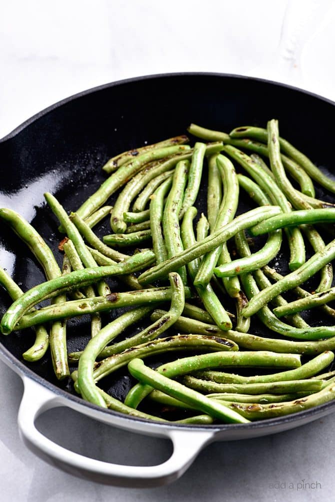 Blistered Green Beans Recipe - These green beans make a quick and easy side dish! Ready in minutes and a delicious favorite! // addapinch.com