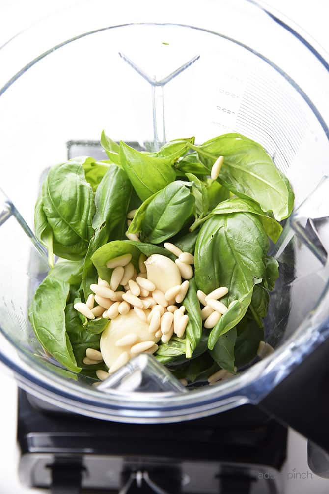 Classic Pesto Recipe - Made of fresh basil, garlic, nuts, olive oil, and cheese, this pesto recipe comes together in minutes and adds so much flavor to so many dishes! // addapinch.com