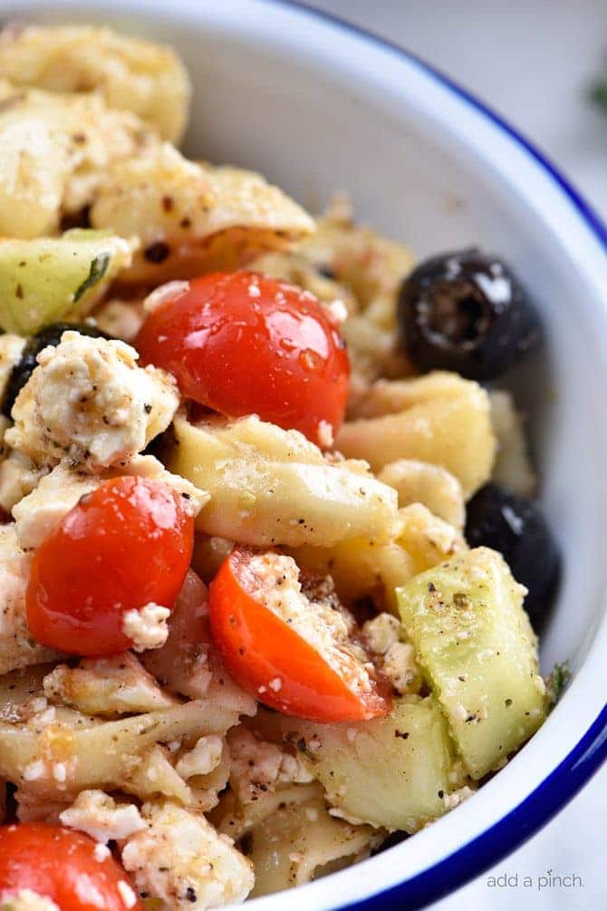 Tortellini salad in white bowl.
