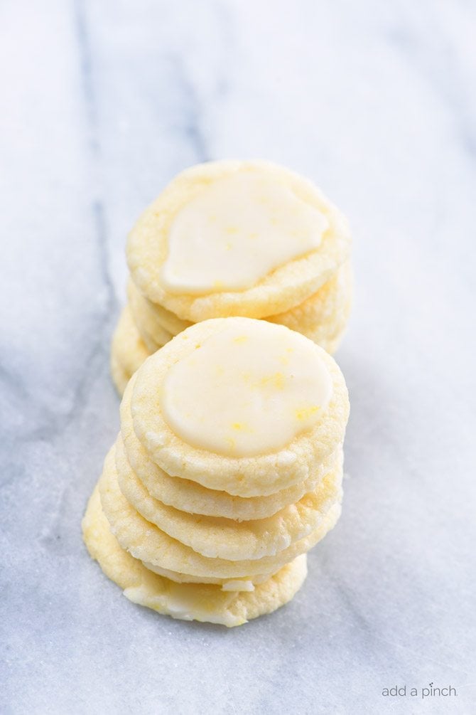 Lemon Shortbread Cookies Recipe - Lemon Shortbread Cookies make a delicious slice and bake cookie recipe perfect for sharing! Made with fresh lemons, this cookie recipe has just the perfect amount of sweet and tart that lemon lovers adore! // addapinch.com