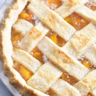 Classic Peach Pie Recipe - This Classic Peach Pie Recipe is a summer staple! Made with a lattice-topped double crust and filled with delicious peaches! // addapinch.com
