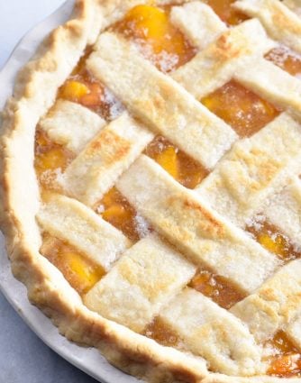 Classic Peach Pie Recipe - This Classic Peach Pie Recipe is a summer staple! Made with a lattice-topped double crust and filled with delicious peaches! // addapinch.com