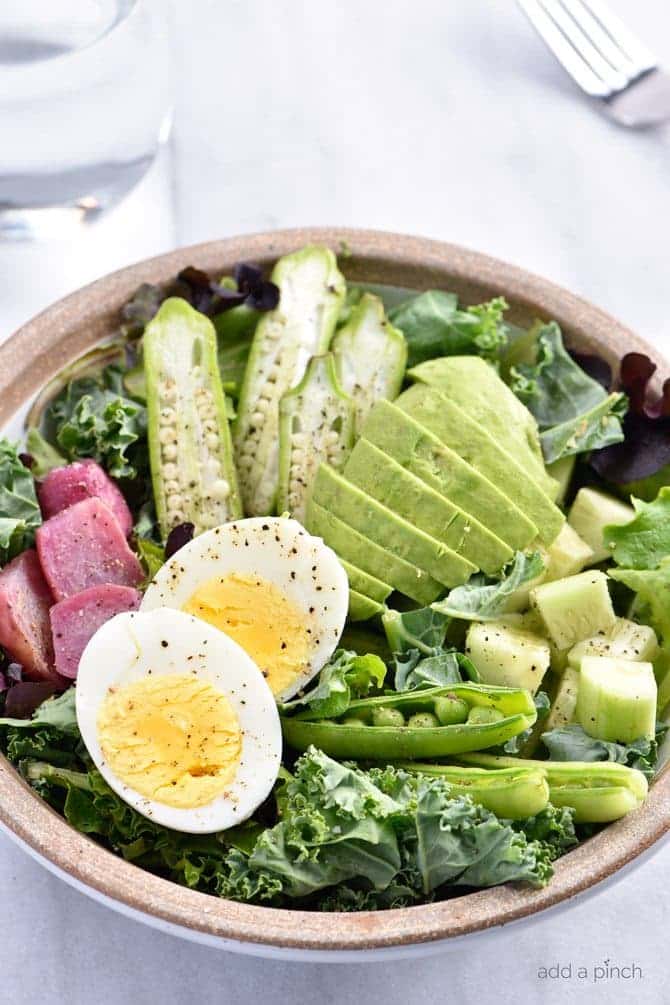 Ultimate Kale Salad Recipe - This Ultimate Kale Salad recipe is the kale salad of my dreams! Filled with crunchy vegetables, creamy avocado and topped with a bold dressing, it is glorious! // addapinch.com