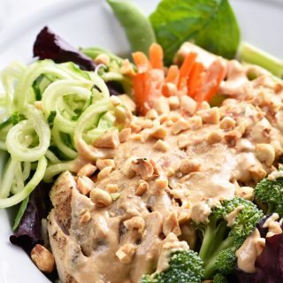 Asian Chicken Salad Recipe - This Asian chicken salad recipe is filled to the brim with flavor! A crisp salad topped with tender chicken, vegetables and a delicious peanut sauce for dressing! // addapinch.com