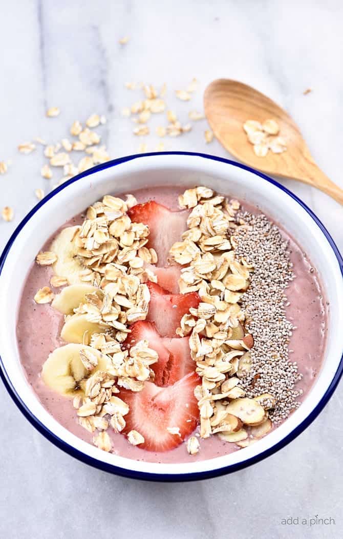 Strawberry Banana Smoothie Bowl Recipe - This strawberry banana smoothie bowl makes a flavorful and delicious fruit, nut, and oat smoothie bowl! Great for breakfast or an afternoon treat! // addapinch.com
