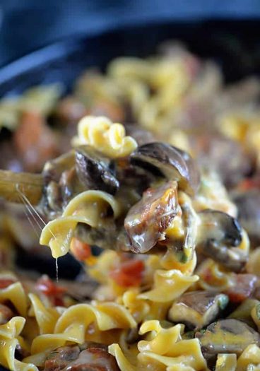Cheesy Mushroom Sausage Pasta Recipe - This cheesy mushroom sausage pasta skillet makes a delicious, quick meal. Made with portobello mushrooms, sausage, pasta, and lots of cheese, this one skillet pasta recipe is a people pleaser! // addapinch.com