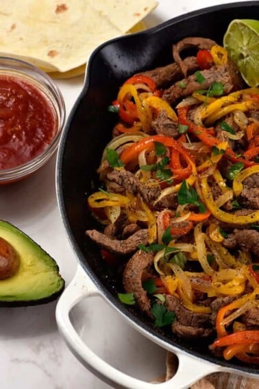 Steak Fajitas Recipe - Steak fajitas make a quick and easy meal perfect for weeknight suppers or weekend celebrations! // addapinch.com
