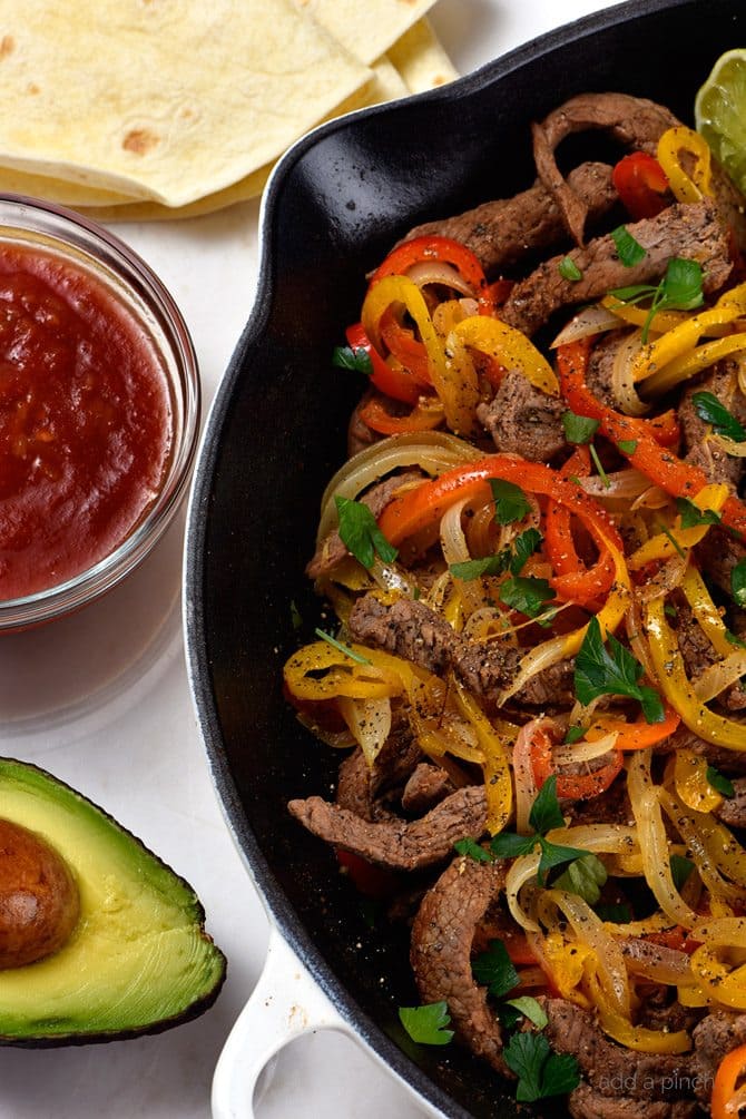 Steak Fajitas Recipe - Steak fajitas make a quick and easy meal perfect for weeknight suppers or weekend celebrations! // addapinch.com