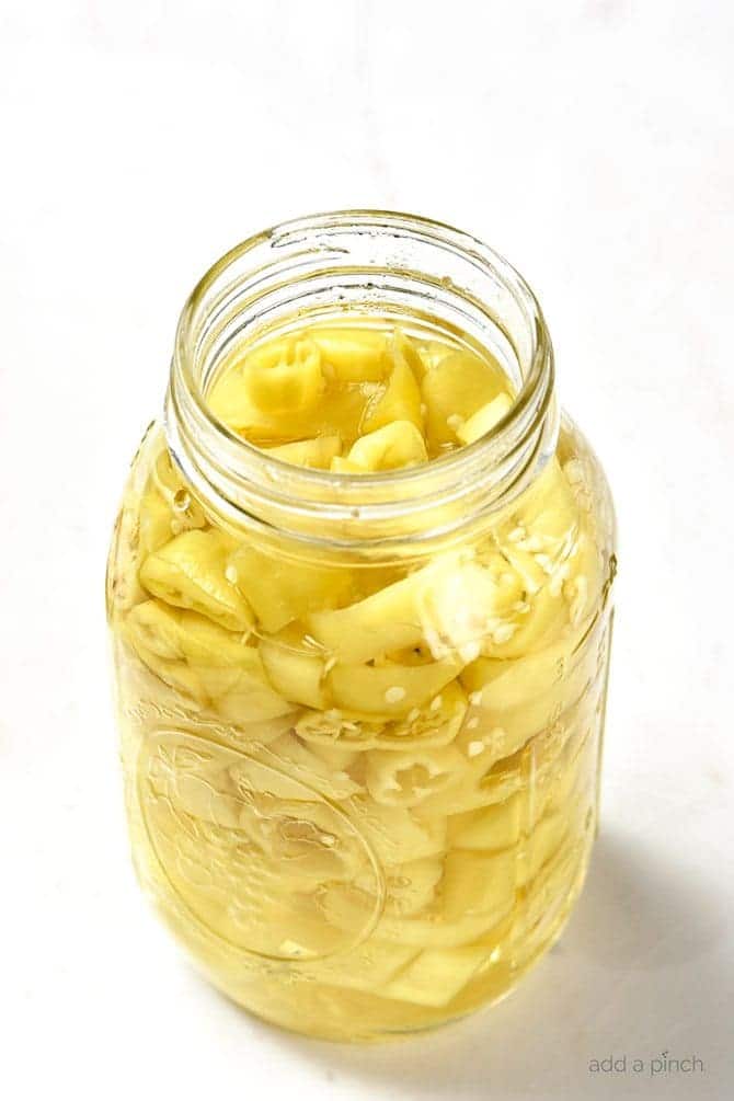 Easy Pickled Peppers Recipe - These Pickled Peppers make a quick and easy way to preserve your banana, jalapeno and other kinds of peppers! Perfect for using throughout the year in dishes like pizzas, soups, salads, sandwiches and so many more! // addapinch.com