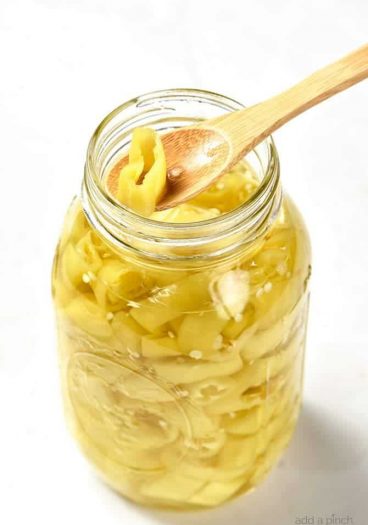 Easy Pickled Peppers Recipe - These Pickled Peppers make a quick and easy way to preserve your banana, jalapeno and other kinds of peppers! Perfect for using throughout the year in dishes like pizzas, soups, salads, sandwiches and so many more! // addapinch.com
