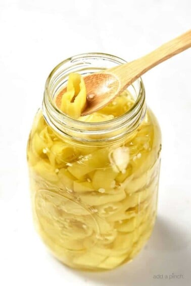 Easy Pickled Peppers Recipe - These Pickled Peppers make a quick and easy way to preserve your banana, jalapeno and other kinds of peppers! Perfect for using throughout the year in dishes like pizzas, soups, salads, sandwiches and so many more! // addapinch.com