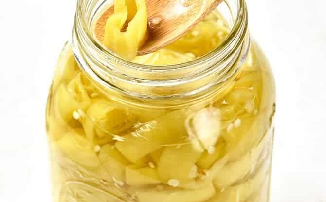 Easy Pickled Peppers Recipe - These Pickled Peppers make a quick and easy way to preserve your banana, jalapeno and other kinds of peppers! Perfect for using throughout the year in dishes like pizzas, soups, salads, sandwiches and so many more! // addapinch.com