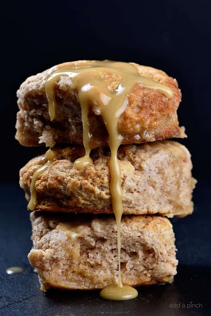 These Sweet Cinnamon Biscuits practically scream fall! But then, when you drizzle them with this Apple Cider Glaze, they become ethereal! So easy to prepare, this is one biscuit recipe that you will want to make again and again! // addapinch.com