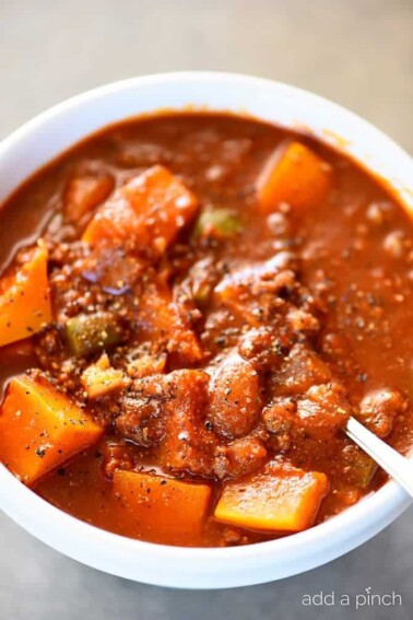 Butternut Squash Chili recipe made with ground beef or turkey, butternut squash, vegetables, and spices makes a hearty and delicious chili recipe! Recipe includes changes for Paleo, Whole 30 and Vegetarian needs. Also includes make ahead and freezer instructions! // addapinch.com