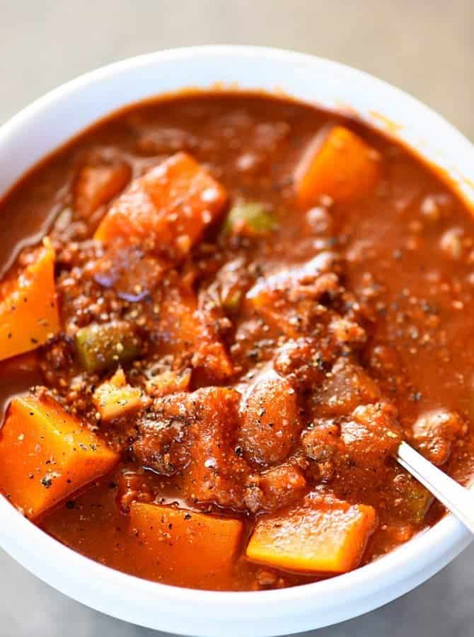 Butternut Squash Chili recipe made with ground beef or turkey, butternut squash, vegetables, and spices makes a hearty and delicious chili recipe! Recipe includes changes for Paleo, Whole 30 and Vegetarian needs. Also includes make ahead and freezer instructions! // addapinch.com