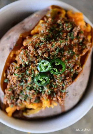Chili Stuffed Sweet Potatoes Recipe - Chili Stuffed Sweet Potatoes makes a quick and easy meal! Ready and on the table in 30 minutes or a great make-ahead meal for even easier weeknights! // addapinch.com