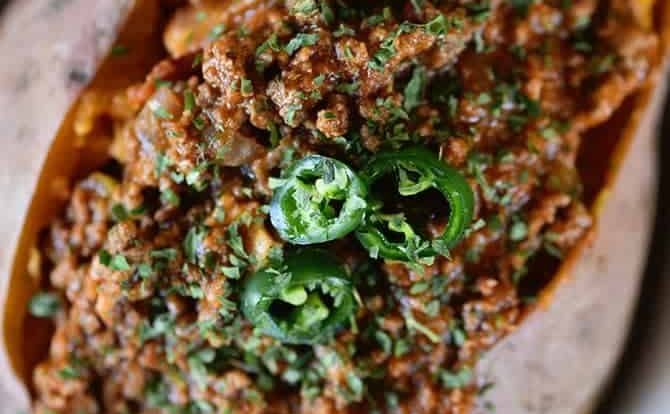 Chili Stuffed Sweet Potatoes Recipe - Chili Stuffed Sweet Potatoes makes a quick and easy meal! Ready and on the table in 30 minutes or a great make-ahead meal for even easier weeknights! // addapinch.com