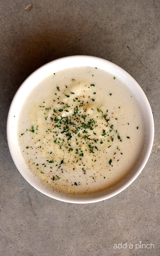 Creamy Cauliflower Soup Recipe - Creamy Cauliflower Soup makes a delicious and comforting soup recipe without a drop of cream! The garlic, onion, and cauliflower are blended together to create a dairy-free, creamy cauliflower soup recipe that everyone loves! // addapinch.com