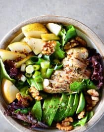 Fall Chicken Avocado Pear Salad Recipe - This salad makes for a delicious fall salad recipe! Filled with chicken, avocado, pears, walnuts, and topped with a Honey Mustard Dressing! // addapinch.com