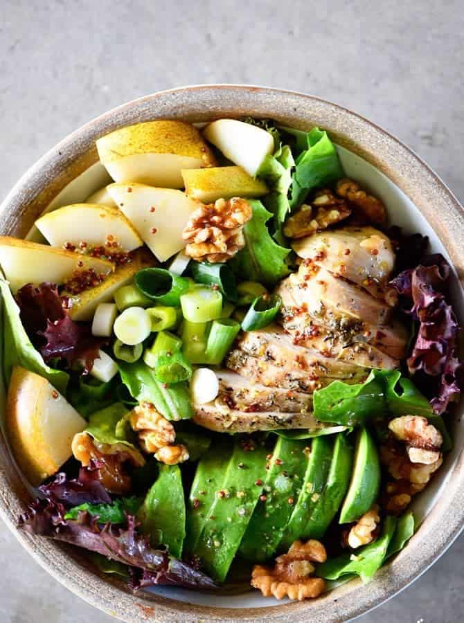 Fall Chicken Avocado Pear Salad Recipe - This salad makes for a delicious fall salad recipe! Filled with chicken, avocado, pears, walnuts, and topped with a Honey Mustard Dressing! // addapinch.com