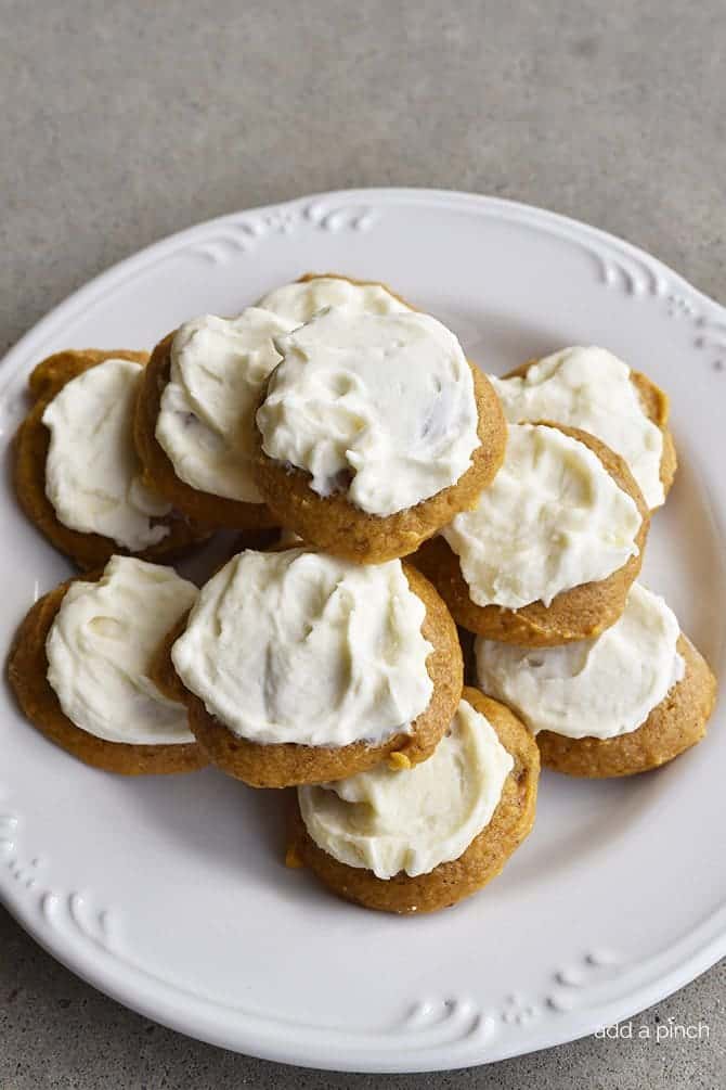 Pumpkin Cookies Recipe with Maple Buttercream Frosting - Pumpkin Cookies with Maple Frosting Recipe make for a soft, delicious cookie recipe! A simple, yet flavorful cookie recipe topped with maple buttercream frosting! // addapinch.com