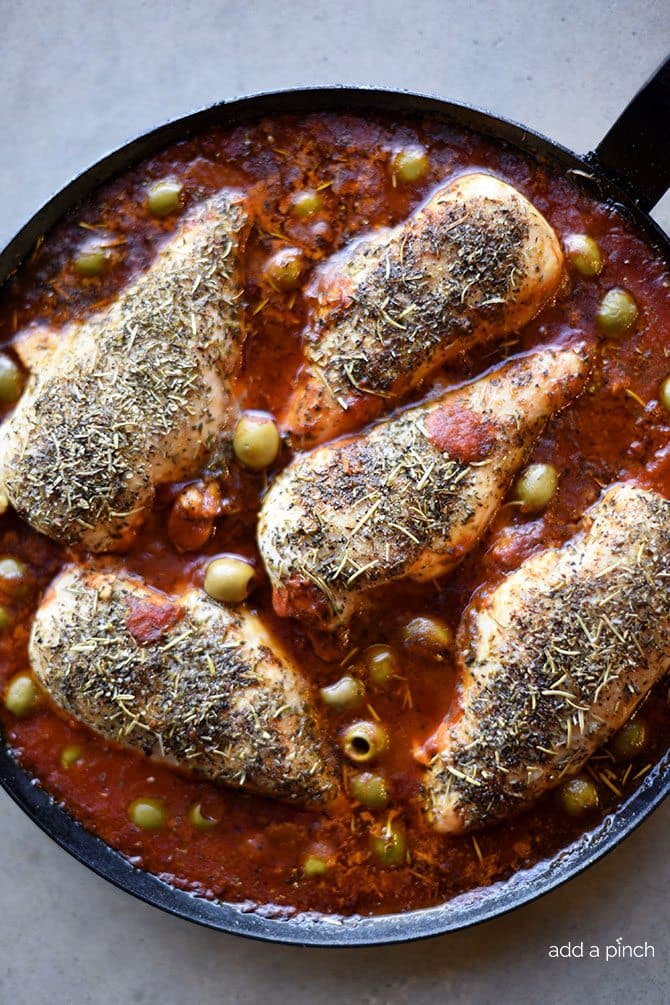 Skillet Mediterranean Chicken Recipe - This quick and easy skillet chicken recipe is packed full of flavor! Simple enough for a busy weeknight, yet perfect for entertaining! // addapinch.com
