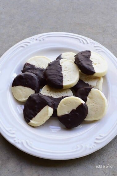 Chocolate Dipped Shortbread Cookies Recipe make a festive and delicious cookie recipe that chocolate lovers adore! Perfect for a make ahead cookie recipe! // addapinch.com