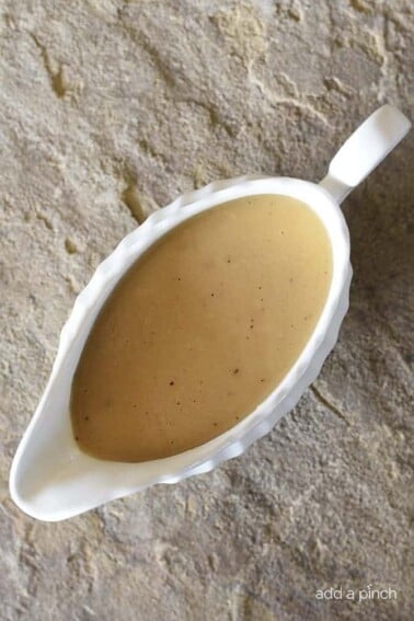 Make-Ahead Turkey Gravy Recipe - This easy turkey gravy recipe is essential to your holiday menu! Simple enough to make on the holiday, but perfect as a make ahead gravy recipe! // addapinch.com