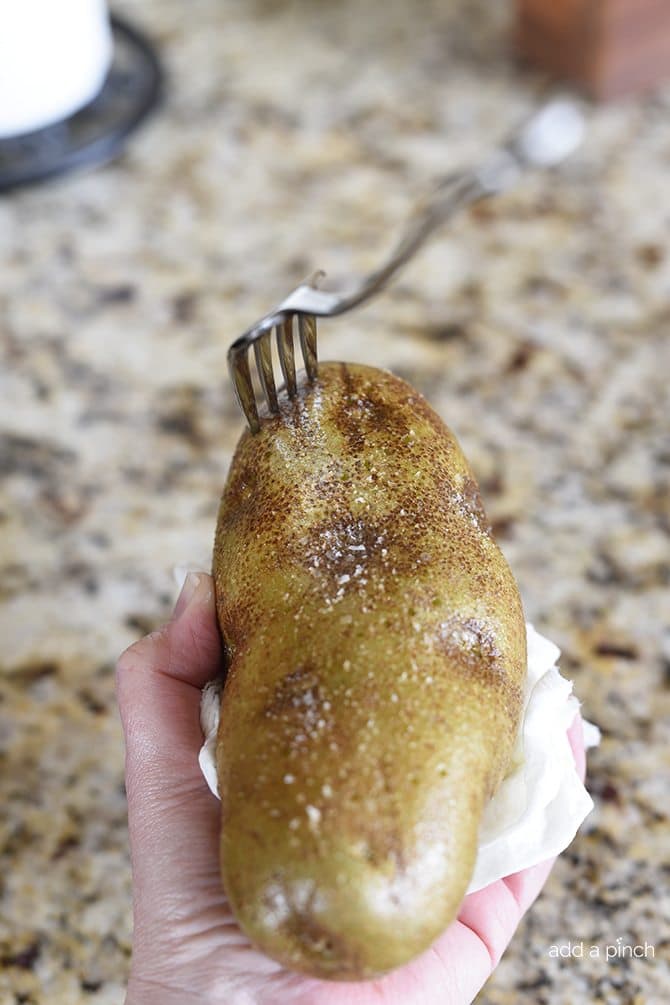 Pricking a potato with a fork prior to baking // addapinch.com