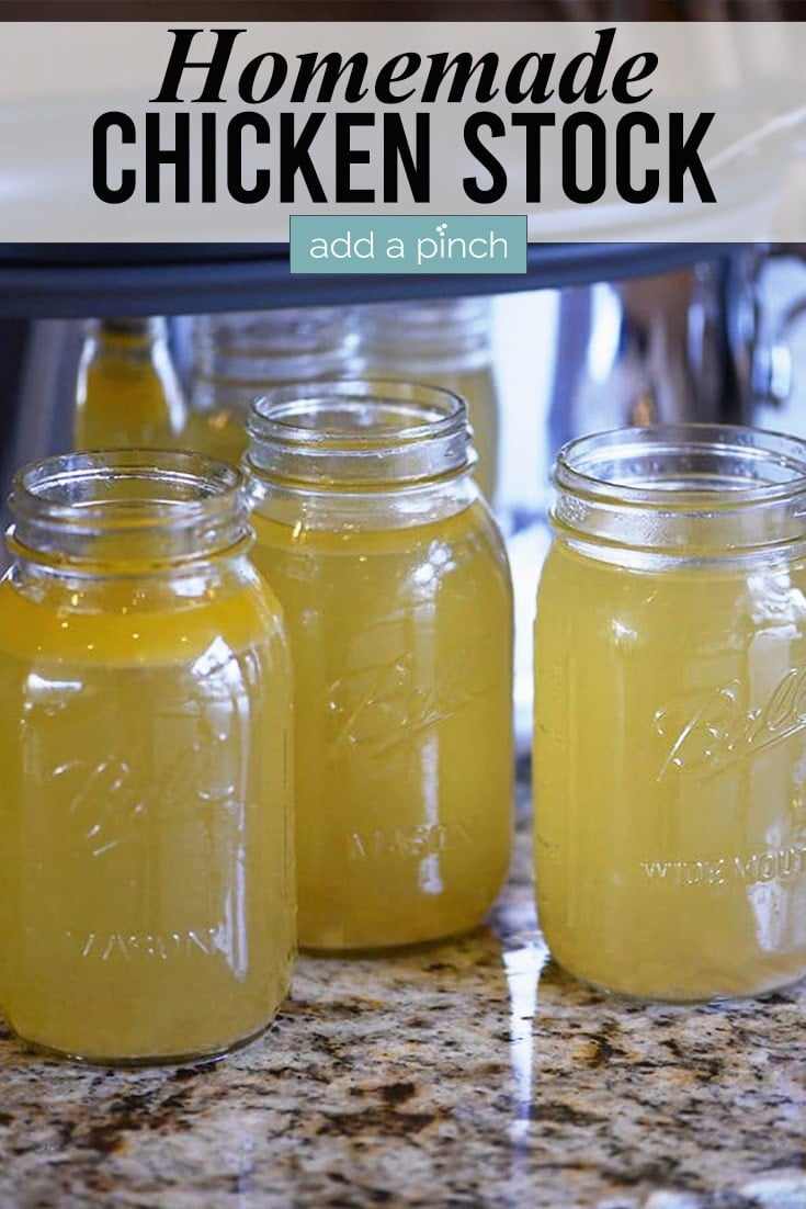 Mason jars filled with homemade chicken stock with slow cooker in the background.