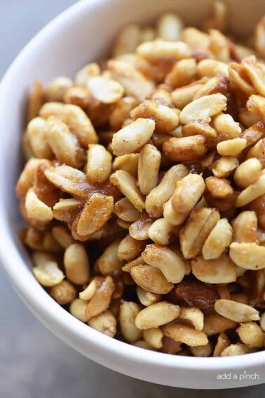 Honey Roasted Peanuts Recipe - Honey Roasted Peanuts make a delicious snack! Made with just four ingredients with one addition if you prefer them spicy! // addapinch.com