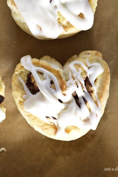 Heart-shaped Cinnamon Rolls Recipe - Heart-Shaped Cinnamon Roll Biscuits make a quick and easy recipe perfect for breakfast, brunch or dessert! All the flavor of a cinnamon roll with the simplicity of a biscuit! // addapinch.com