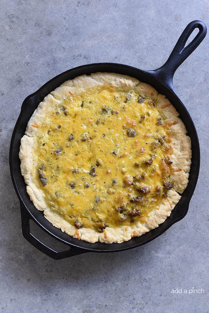 Iron skillet with sausage cheese quiche with browned biscuit crust // addapinch.com