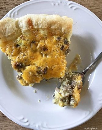 Southern Sausage Cheddar Quiche Recipe - This Southern Sausage Cheddar Quiche recipe makes a quick and easy breakfast recipe. Ready and on the table in 30 minutes, it is a Southern update to a classic! // addapinch.com