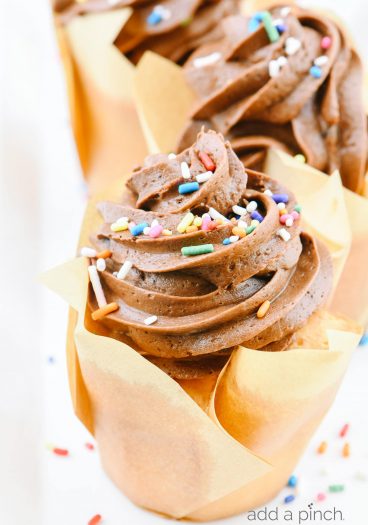 An easy recipe for vanilla cupcakes topped with a delicious chocolate buttercream frosting. They make the perfect cupcakes for every occasion! // addapinch.com