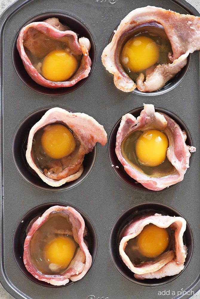 Bacon Egg Cups Recipe - Bacon Egg Cups make a delicious recipe perfect for serving for breakfast, brunch or snack! Great to make for a crowd or to make ahead and reheat for busy mornings! // addapinch.com