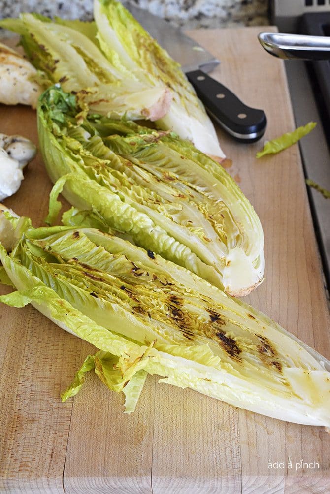Grilled Caesar Salad Recipe - This Grilled Caesar Salad made a delicious twist on a classic caesar salad recipe. Ready in less than 30 minutes, the added char from the grill adds just the right amount of smokiness to the salad while still leaving it crisp. // addapinch.com