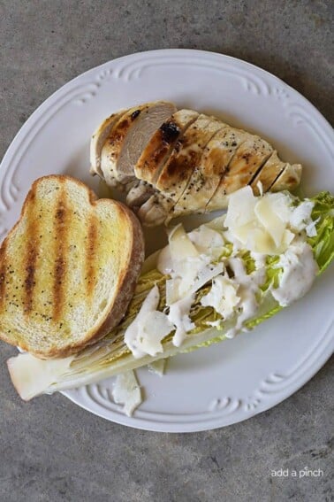 Grilled Caesar Salad Recipe - This Grilled Caesar Salad made a delicious twist on a classic caesar salad recipe. Ready in less than 30 minutes, the added char from the grill adds just the right amount of smokiness to the salad while still leaving it crisp. // addapinch.com