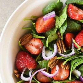 Strawberry Spinach Salad Recipe - Strawberry Spinach Salad topped with an easy Poppy Seed Dressing makes for a beautiful and delicious spring and summer salad recipe. Perfect for parties, picnics, and get-togethers! Always a crowd favorite! // addapinch.com