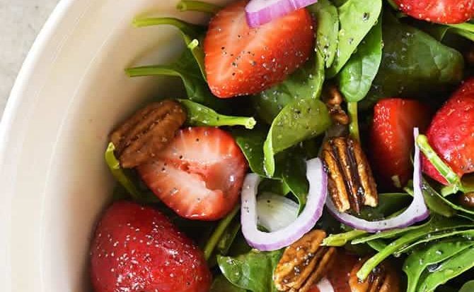 Strawberry Spinach Salad Recipe - Strawberry Spinach Salad topped with an easy Poppy Seed Dressing makes for a beautiful and delicious spring and summer salad recipe. Perfect for parties, picnics, and get-togethers! Always a crowd favorite! // addapinch.com