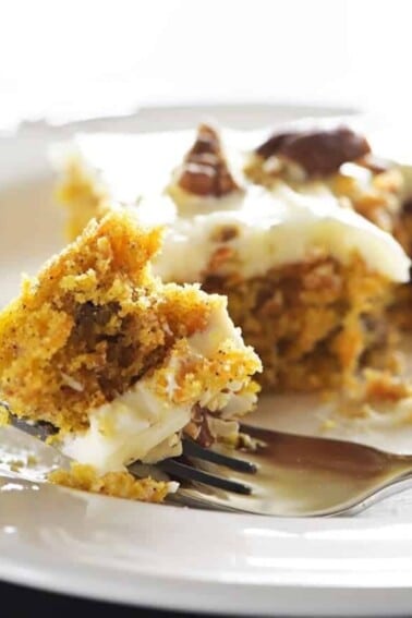 Bite of carrot cake with cream cheese frosting.