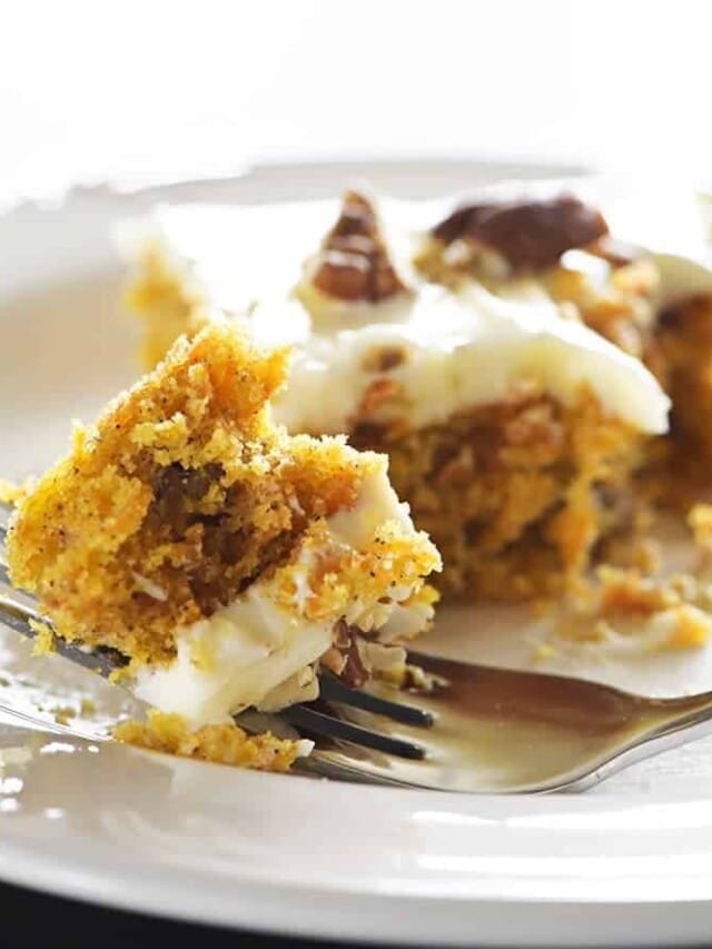 Bite of carrot cake with cream cheese frosting.