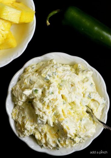 Pineapple Jalapeno Cream Cheese Spread - This quick and easy recipe comes together in a snap with just four ingredients! This sweet and spicy cream cheese spread is perfect for sandwiches, wraps, crackers or bagels! // addapinch.com