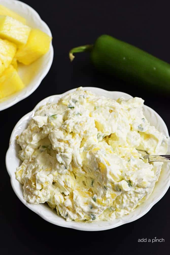 Pineapple Jalapeno Cream Cheese Spread - This quick and easy recipe comes together in a snap with just four ingredients! This sweet and spicy cream cheese spread is perfect for sandwiches, wraps, crackers or bagels! // addapinch.com