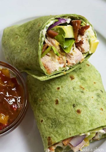 Sweet and Spicy Chicken Wraps - Quick, easy and oh so delicious! This chicken wraps recipe is made with chicken, bacon, cucumbers, red onions, and a special sweet and spicy spread! // addapinch.com