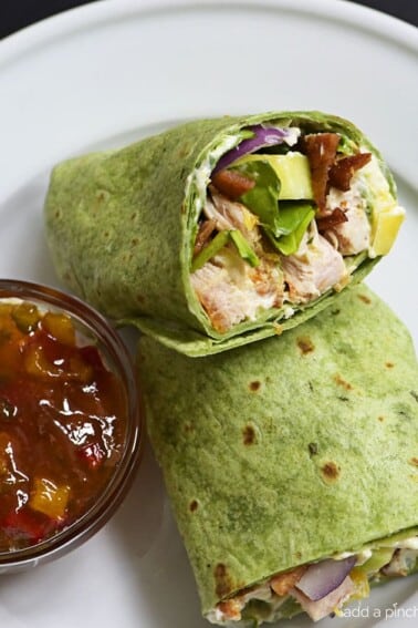 Sweet and Spicy Chicken Wraps - Quick, easy and oh so delicious! This chicken wraps recipe is made with chicken, bacon, cucumbers, red onions, and a special sweet and spicy spread!